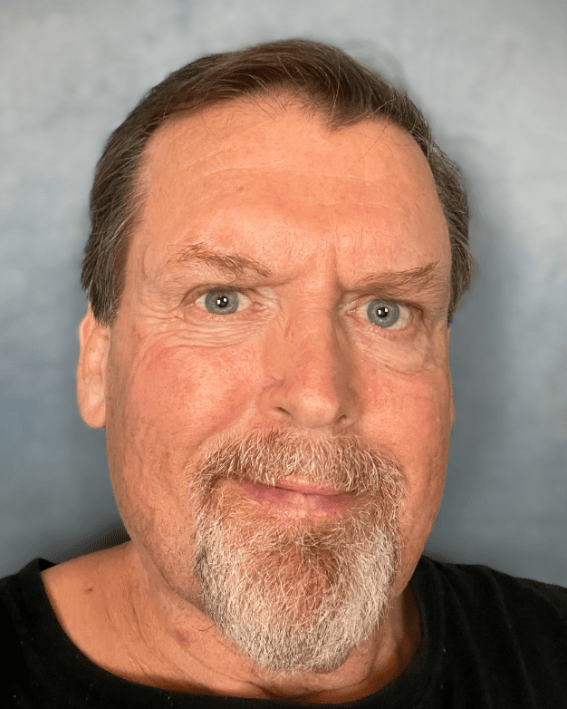 Man with a beard and blue eyes.