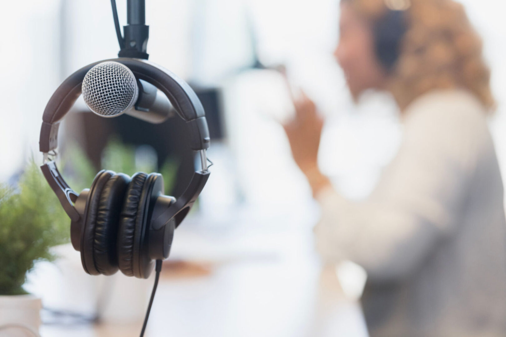 Microphone with headphones in recording studio.
